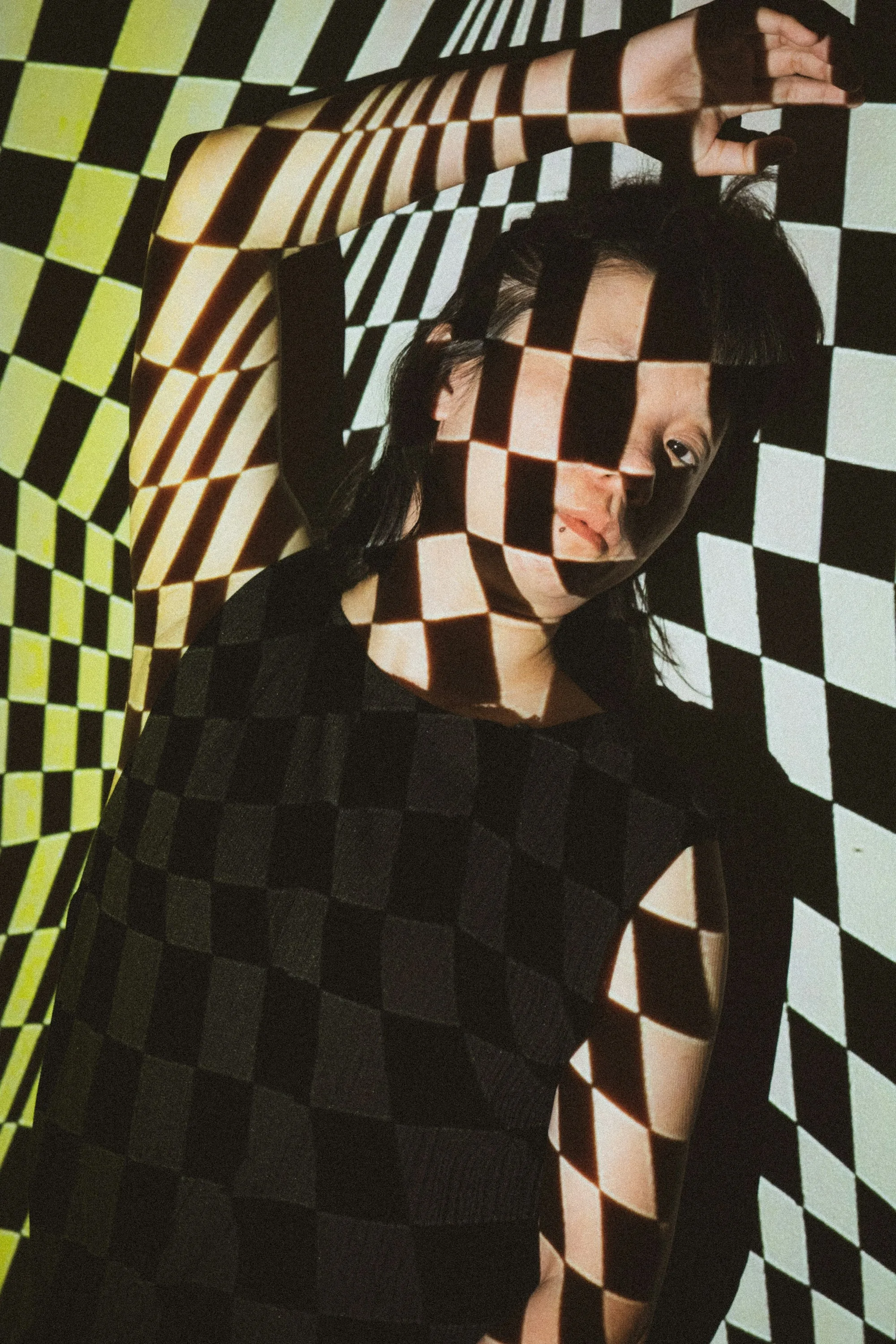 A graphic portrait with patterned light and shadow