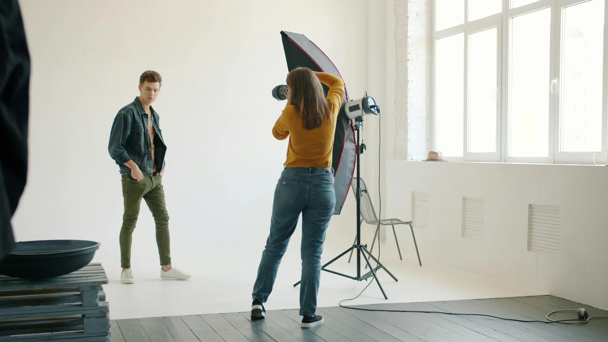 Photographer directing a portrait shoot in a studio